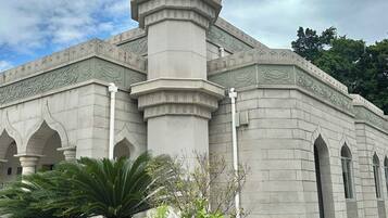 A mosque with a central dome, minarets, and arched windows.