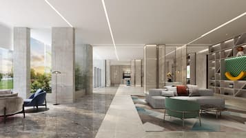 A modern lobby with a marble floor, seating area, and a view of the outdoors.