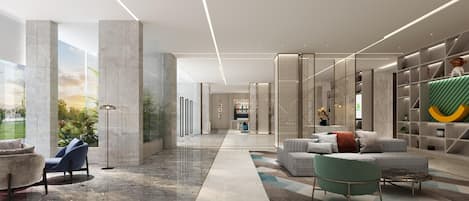 Un vestíbulo moderno con piso de mármol, zona de estar y vistas al exterior.