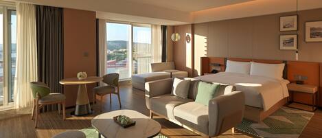 A modern hotel room with a large bed, two armchairs, a small table, and a view of the city.