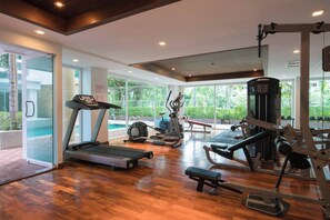 A gym with treadmills, elliptical machines, and weight equipment.