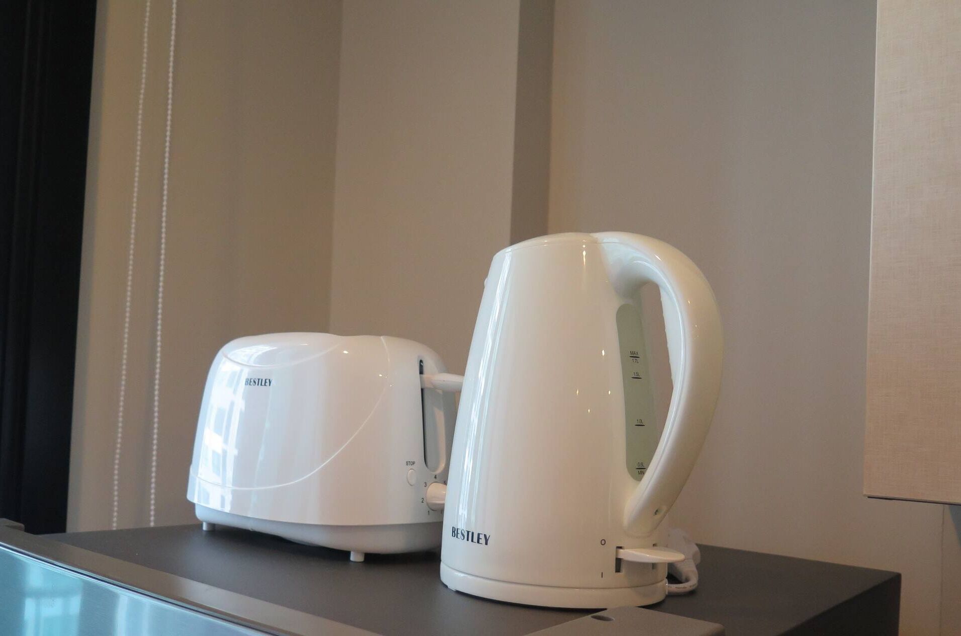 Two white electric kettles on a table.