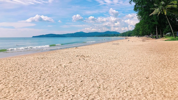 A beach with a sandy shore, calm sea, and distant hills. - Luxe 2br Pool Villa walk to Bangtao Beach (Tambon Choeng Thale)