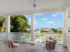 Relax by the pool with a view of the surrounding buildings from this serene outdoor space.