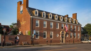 A historic brick building with multiple windows and a flag. - Crow's Nest Newport (Newport)