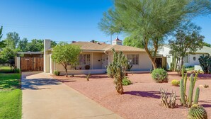 A single-story house with a front porch, a small garden with cacti, and a clear blue sky. - Phoenix Home w/ Patio: Near Downtown & Light Rail! (Phoenix)