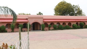 A building with a reception area, arched windows, and a paved courtyard. - Balibago Hotel Angeles powered by Cocotel (Gaborone)