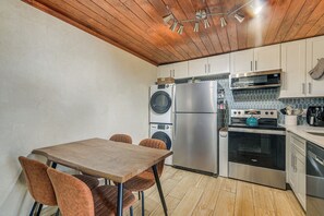 A compact kitchen with a wooden ceiling, a washing machine, a refrigerator, a microwave, and a stove. - 2 Blocks to Sand! Breezy Atlantic Beach Escape (Myrtle Beach)