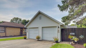 A single-story house with a garage, a brick exterior, and a well-maintained lawn. - Private Plainfield Retreat w/ Gas Grill + Patio (Plainfield)
