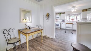 A kitchen with a wooden table, two chairs, a microwave, and a ceiling fan. - Private Plainfield Retreat w/ Gas Grill + Patio (Plainfield)