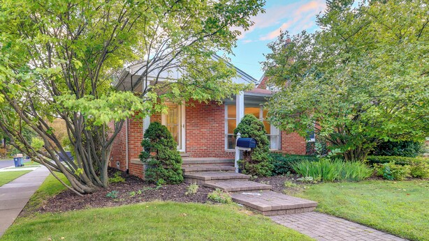 A brick house with a front yard, a mailbox, and a small tree. - Royal Oak Home: 13 Mi to Downtown Detroit (Royal Oak)
