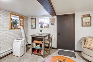A compact living space with a kitchenette, a dining area, and a seating area.