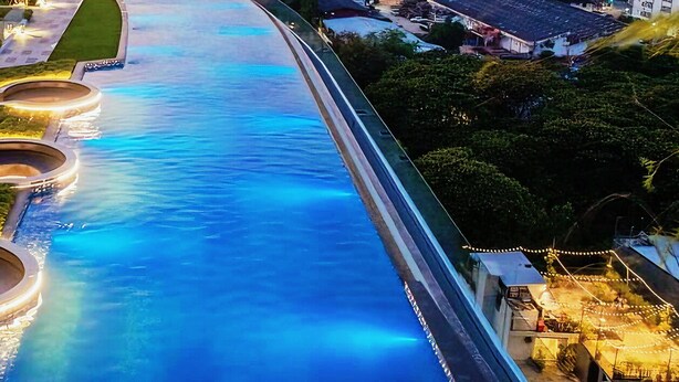 A river with illuminated circular structures, a pathway, and greenery. - Sky pool Holiday home near Tha Phae Gate Old town 2 bedroom (Chang Wat Chiang Mai)