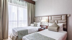 A hotel room with two beds, a large window with curtains, a nightstand with a lamp, and a wall-mounted thermostat. - Three Bedroom Apartment In Sadaf 3 Jbr By E R (Dubai)