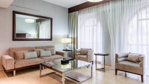 A modern hotel room with a sofa set, a coffee table, a side table, and a large window with curtains. - One Bedroom Apartment In Sadaf 3 Jbr By E R (Dubai)