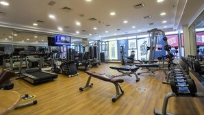 A gym with treadmills, weight benches, and various exercise equipment. - One Bedroom Apartment in Al Qusais By E R (Dubai)