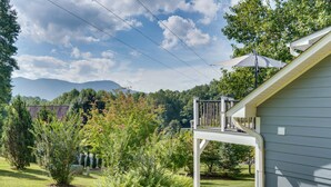 A residential property with a covered porch, a landscaped garden, and a view of mountains in the background. - Young Harris Vacation Rental w/ Mountain Views! (Young Harris)