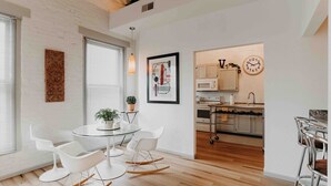 A modern kitchen with white cabinets and a microwave. - Skyline View Penthouse Apartment (Mansfield)
