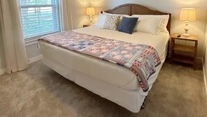 A bedroom with a bed, two bedside lamps, a ceiling fan, and a window with curtains. - The Red Gate - Branson & Eureka!
 (Green Forest)