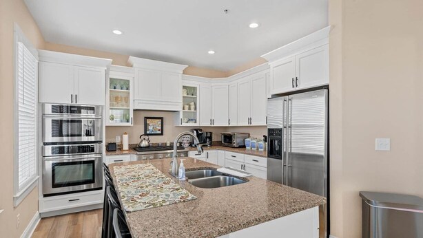 A kitchen with white cabinets, stainless steel appliances, a granite countertop, and a built-in sink. - ⭐️ Brand New, Fully Renovated Home Steps to Boardwalk Beach (Ocean City)
