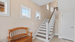 A staircase with white railings and wooden steps, a wooden bench, and a door. - ⭐️ Brand New, Fully Renovated Home Steps to Boardwalk Beach (Ocean City)