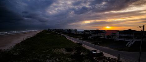 A coastal road with houses and a beach.