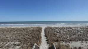 A beach path leading to the ocean with dry grass on either side. - Sea Vista Motel (Holly Ridge)