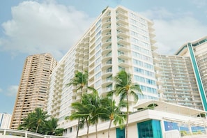 A multi-story hotel with balconies and a modern architectural design.