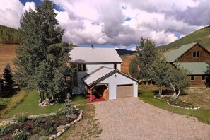 A two-story house with a covered porch and a garage. - Paradise Vista, Comfortable Home, Incredible views! (Crested Butte)