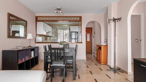 A modern kitchen with a dining area, a large mirror, and a compact living space. - Zeus Apartment Riviera del Sol by Costarentals - Ref 221 (Mijas)