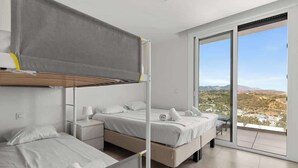 A modern hotel room with a balcony, two beds, and a view of the landscape. - Casa Banderas Pool & Gym by Costarentals - Ref 237 (La Cala de Mijas)