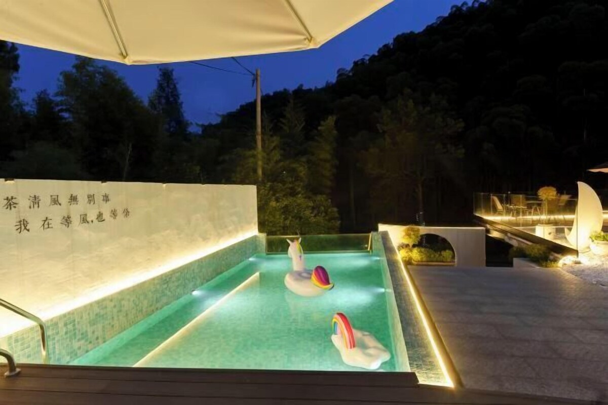 A swimming pool with swan-shaped floats and a canopy overhead.