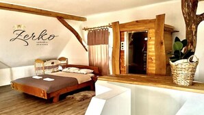 A cozy bedroom with a wooden bed, a large window, and a rustic wooden ceiling. - Vineyard Chalet With Jacuzzi and Sauna for FREE (Trebnje)