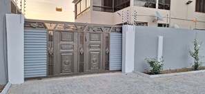 Traditional entrance to a residence with a beautifully manicured garden.