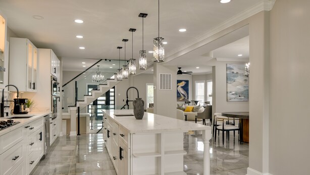 A modern kitchen with white cabinetry, a marble countertop island, and pendant lighting. - 5 Mi to Inner Harbor: Expansive Family Getaway (Baltimore)