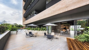 An outdoor patio area with modern furniture and a view of the city. - The new apartment, very bright, all brand new fully equipped so that you... (Medellín)