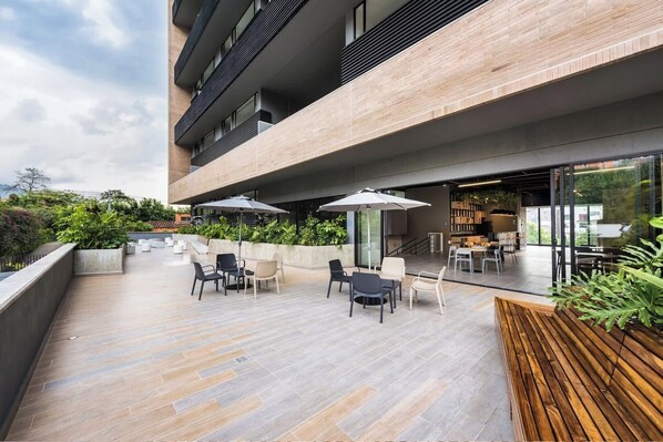 An outdoor patio area with modern furniture and a view of the city.