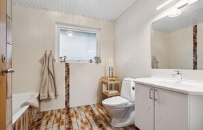 A bathroom with a toilet, sink, and window. - 3 bedroom lovely home in Vestervig (Vestervig)