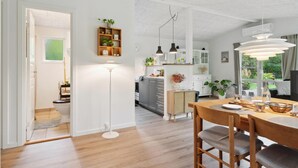 A modern kitchen with a dining area, wooden flooring, and pendant lighting. - Amazing home in Gørlev with WiFi (Gørlev)