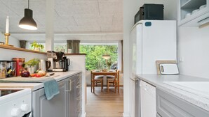 A modern kitchen with a dining area, wooden flooring, and a view of greenery outside. - Amazing home in Gørlev with WiFi (Gørlev)