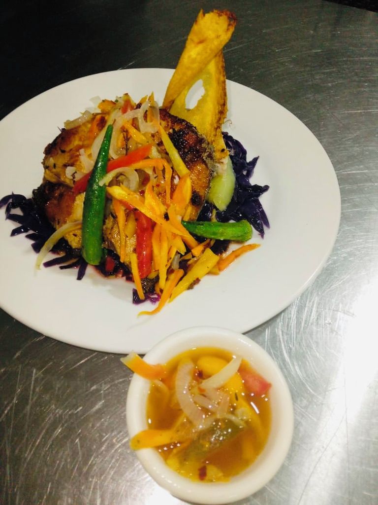 A plate of food with a side of soup.