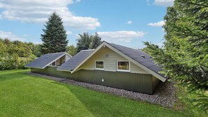 A two-story house with a sloped roof, a small porch, and a well-maintained lawn. - Amazing home in Toftlund with WiFi (Toftlund)