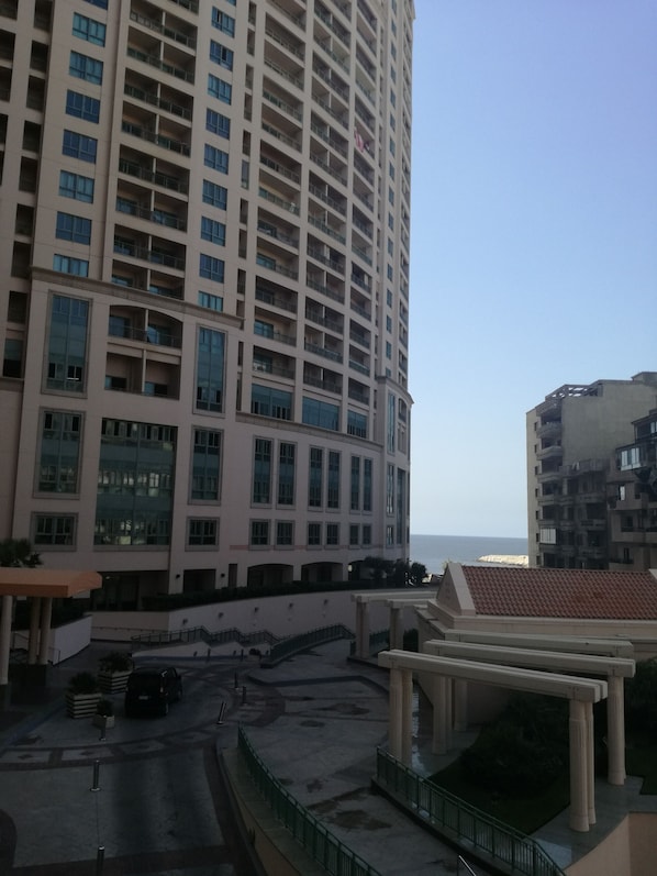 A high-rise building with multiple balconies and large windows.