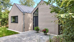 A modern two-story building with a grey exterior and a dark-colored door. - Lovely home in Oosterwolde with WiFi (Oosterwolde)