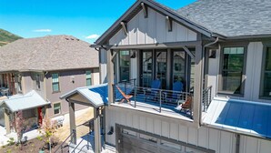 A two-story house with a covered front porch, a garage, and a well-maintained garden.