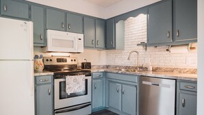A kitchen with teal cabinets, a white refrigerator, a microwave, a stove, and a dishwasher. - Beautiful, Peaceful Lakefront home in ❤️ of Bourbon Country in Shelbyville, KY (Shelbyville)