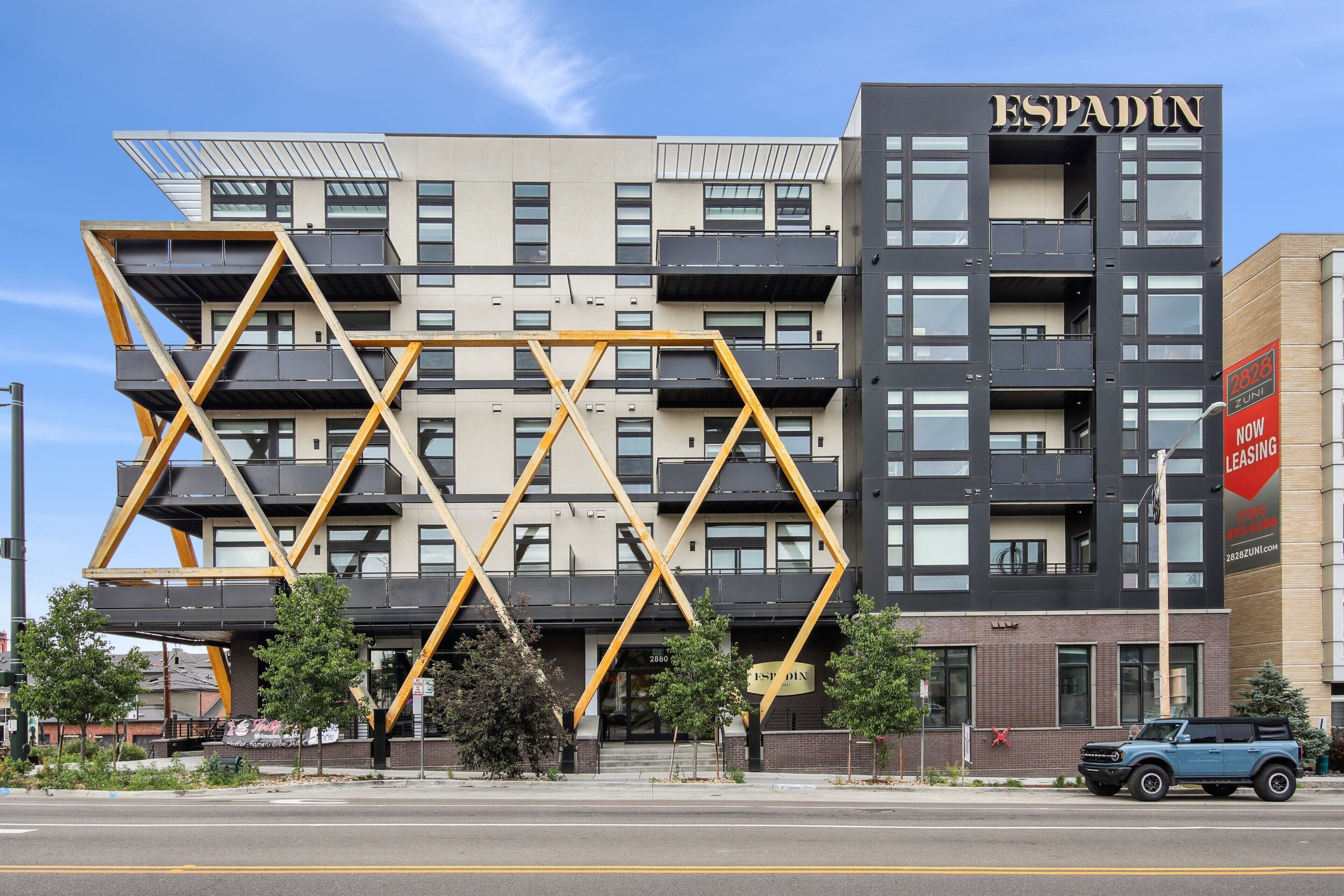 A modern building with a distinctive geometric facade and balconies.