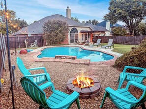 A backyard with a swimming pool, fire pit, and outdoor seating. - Villa with Pool, BBQ and More (Flower Mound)