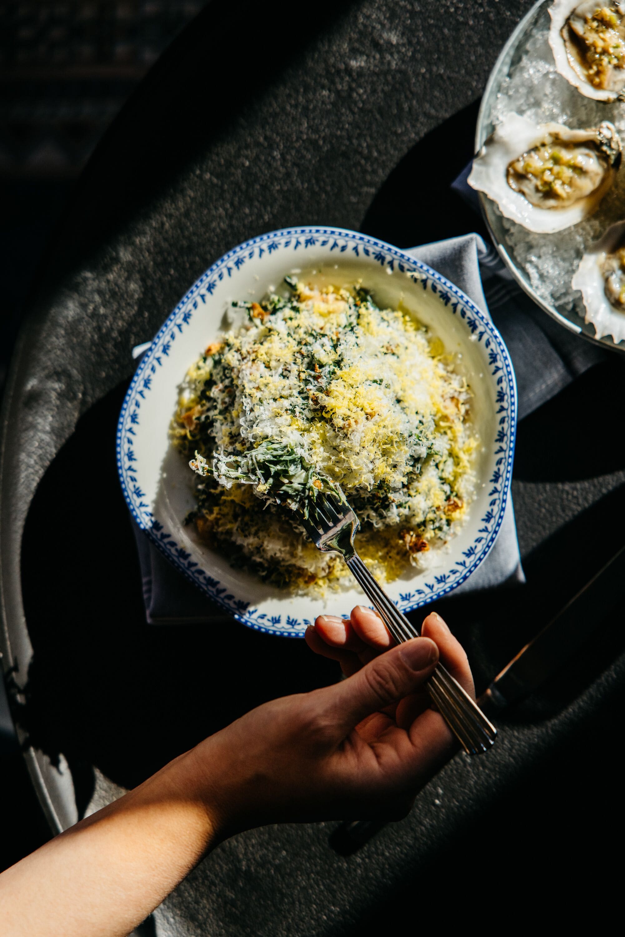 A plate of food with a fork, placed on a table.