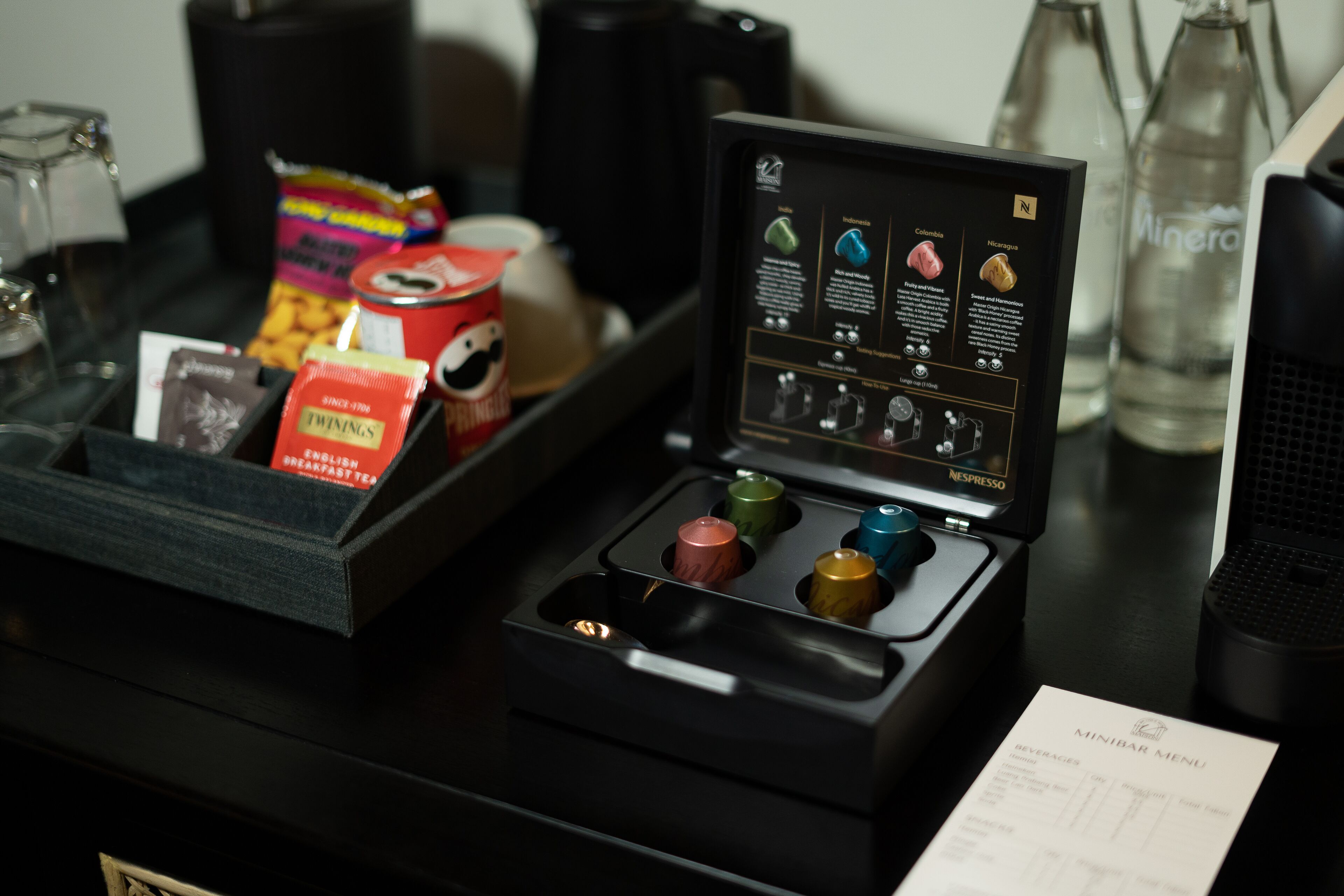 A minibar with a menu, snacks, and a coffee machine.